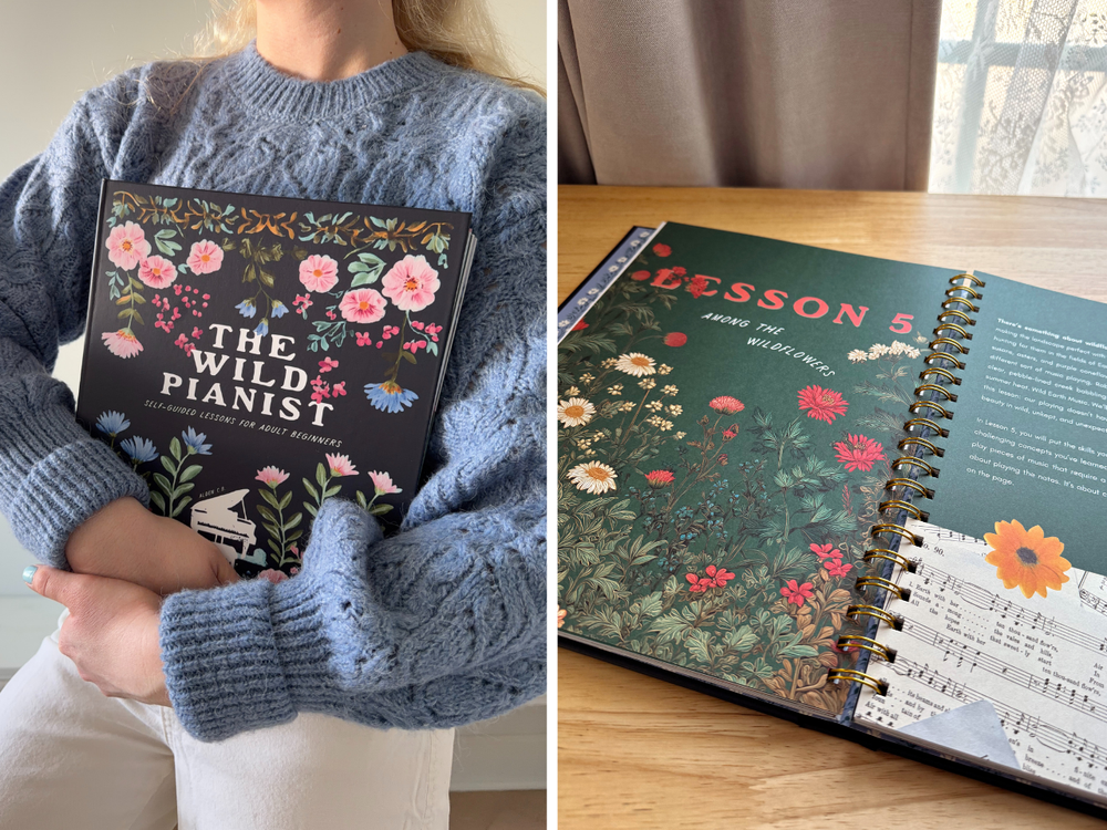 Person holding a book titled 'The Wild Pianist' with floral design, next to a spiral-bound book on a table.