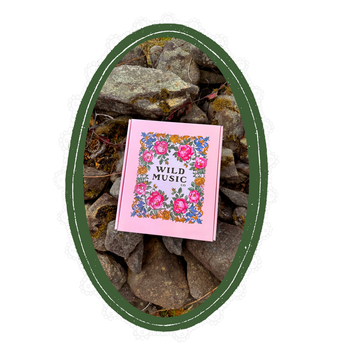 Pink box with floral design and 'Wild Music' text on a pile of rocks.
